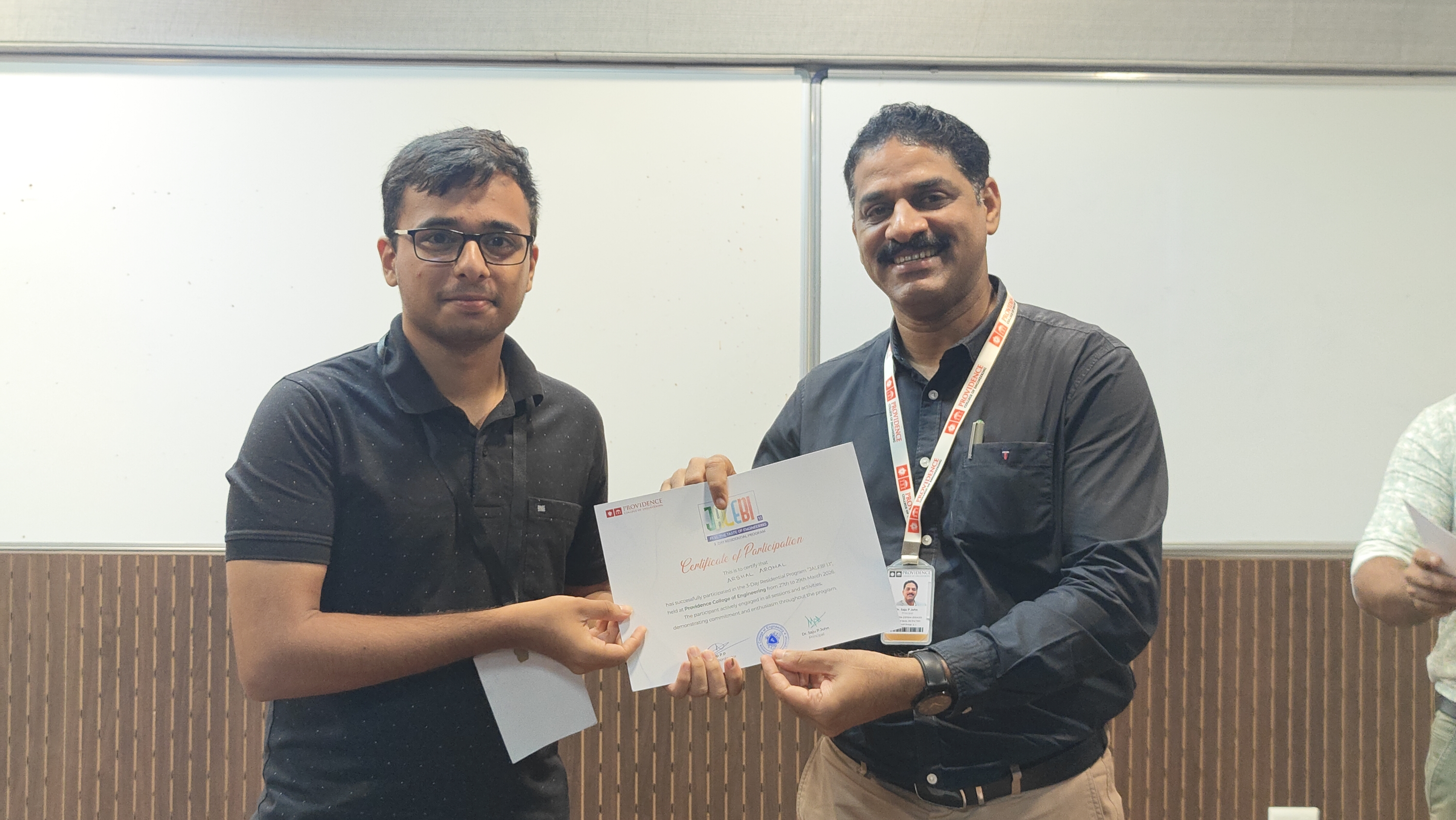 Arshal receiving participation certificate from Dr. Saju P John at Jalebi 1.1 camp in Providence College of Engineering, Chengannur.